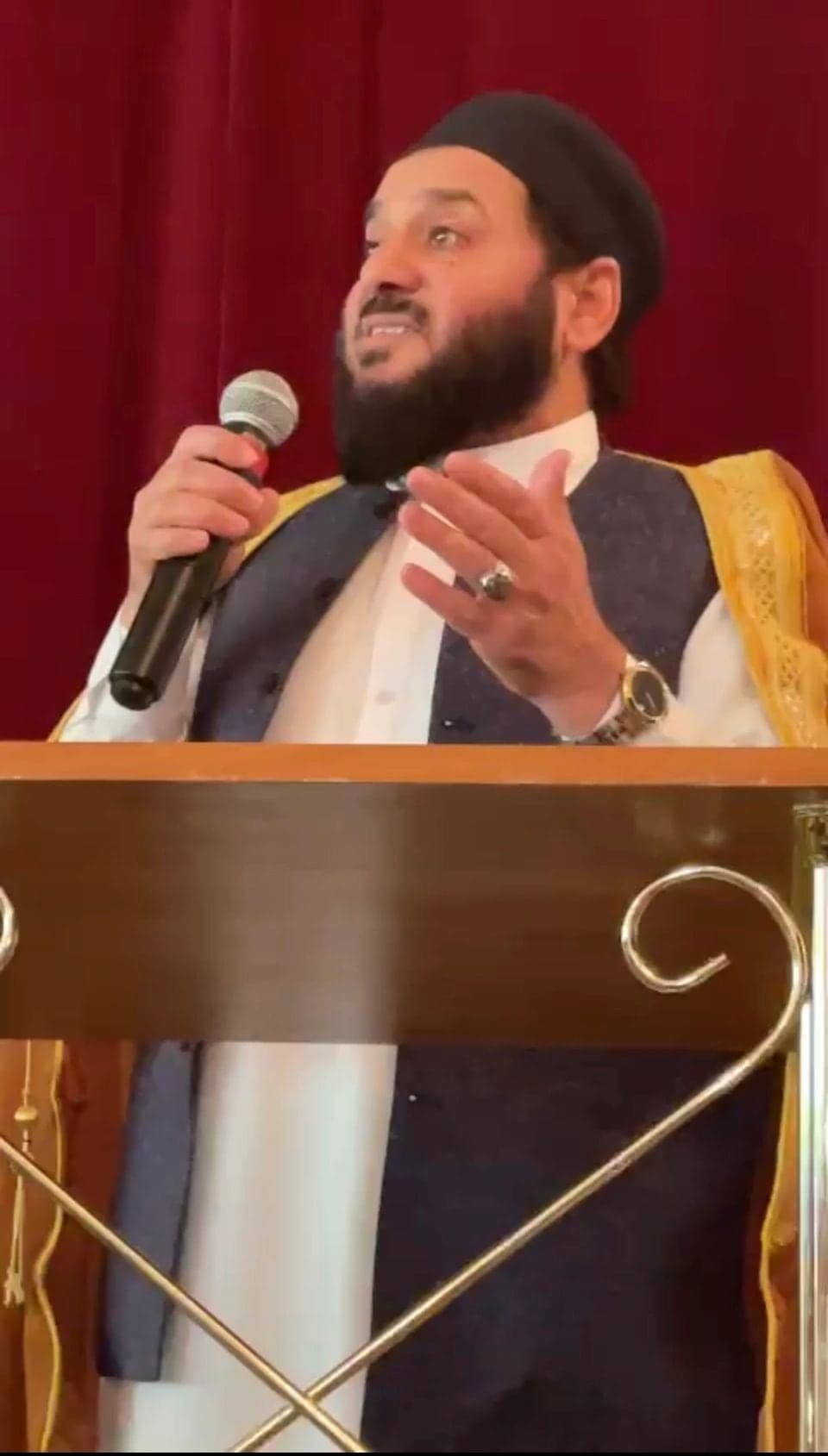 A speaker addressing the community from a lectern